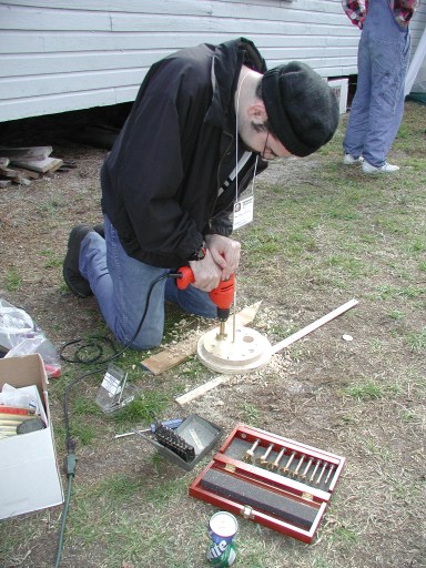 drilling holes in the wooden mirror cell